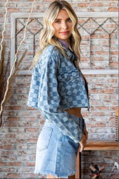 Denim jackets are a fashion staple. This denim shirt jacket features two denim colors woven into a unique checkered pattern. The crop styling features a four button front, button flap pockets and button cuffs. It has a back straight yolk accented with off-center pleats. The double top stitched collar has rounded points and the jacket has an unfinished hem. This is the perfect topper for sun dresses and anytime you need a medium-weight layer. Woven Two-Tone Denim Checkered Pattern Button Front, P Spring Plaid Denim Outerwear, Chala Handbag, Denim Shirt Jacket, Sun Dresses, Handbag Charms, Curvy Dress, Denim Jackets, Checkered Pattern, Colored Denim