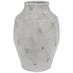 a white vase with brown speckles on the top and bottom, sitting in front of a white background