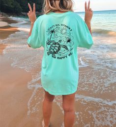 Salty sea, vitamin D, HAPPY ME!  This is the perfect shirt for your next beach trip, or as a gift for the ocean lover in your life. This Comfort Colors garment-dyed t-shirt is made with 100% ring-spun US cotton that is ethically grown and harvested. The soft-washed, garment-dyed fabric brings extra coziness to your wardrobe while the relaxed fit makes it an excellent daily choice. The double-needle stitching throughout the tee makes it highly durable while the lack of side-seams helps the shirt Tropical Print T-shirt For Beach, Blue Hawaiian T-shirt For Beach, Short Sleeve Tropical Beach Top, Tropical Print T-shirt For Beach Season, Tropical Beach Cover-up Top For Beach Season, Green Beach Tops For Beach Season, Casual Ocean Color Beach Tops, Green Beachwear Tops For Beach, Casual Ocean Color Tops For Beach