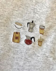 several embroidered objects are shown on a white shirt