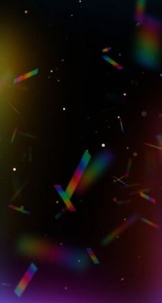 an abstract background with bright colors and sparkles in the dark space, like stars or confetti