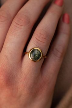 One of a kind is an understatement when it comes to our Juno ring. The main attraction is the Moss Agate stone. An authentic gemstone, each one unique with the mossy texture captured, the Juno ring compliments any style and is the perfect unique gift for a loved one. Details: Center Gemstone: Moss Agate Stone Shape: Round Measurements: 10mm Band measurements: approx. 1.8mm wide, approx. 1.5mm thick Pictured in vermeil, available also in sterling silver or rose gold vermeil. Gold vermeil is not t Nature-inspired Moss Agate Round Rings, Nature-inspired Moss Agate Rings, Pretty Trinkets, Planet Ring, Black Spinel Ring, Moss Agate Stone, Moss Agate Ring, London Blue Topaz Ring, Dope Jewelry