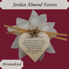 a heart shaped plaque with a bow and ribbon on it that says, jordan almond favors