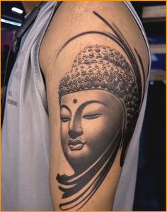 a black and grey buddha tattoo on the arm