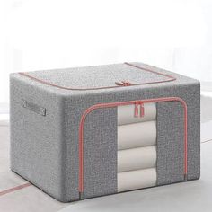 a gray and red storage box on the floor