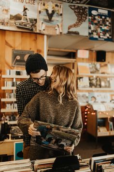 a man and woman looking at records in a record store