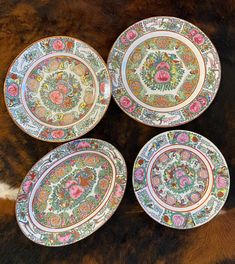 four plates sitting on top of a cow fur covered floor