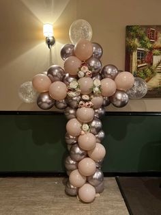 a cross made out of balloons and flowers