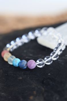 Thrive in your Quartz chakra bracelet! Wear this gorgeous bracelet every day and never forget the importance of taking care of you and your needs. Fill your cup so much it runs over and pours out into everything else you do. Quartz is the power stone that encourages crystal clarity on your path. This paired with the 7 Chakra crystals bring balanced energy across your chakras that allows you to truly thrive! AAA chakra gemstone & clear quartz beads 8mm Amethyst, Lapis Lazuli, Turquoise, Fluorite, Handmade Cheap Crystal Bracelet For Beach, Spiritual Stretch Bracelet With Natural Stones, Everyday Spiritual Stretch Bracelet With Natural Stones, Spiritual Rainbow Crystal Bracelet With Round Beads, Holistic Healing Gemstone Beads Bracelet, Rainbow Jewelry With 8mm Beads For Healing, Spiritual Crystal Bracelet With 8mm Beads For Meditation, Spiritual Gemstone Beaded Bracelets For Everyday, Holistic Crystal Bracelet With Gemstone Beads For Meditation