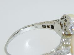 "This exquisite little treasure features 3 luscious white pearls surrounded by 14 small old European and old mine cut diamonds . Set in 18K white gold. The ring is a size 6.75. Setting measures approx. 1/2\" tall. This ring is in excellent pre-owned vintage condition. Total weight is approx. 4.8 grams. (T8 * MJP038283) Please review all photos before purchasing and feel free to ask questions about the item :) For more information you can call us at 360-657-5276. We are sorry but we do NOT offer Vintage White Pearl Ring With Brilliant Cut, Heirloom White Gold Pearl Ring With Rose Cut Diamonds, Anniversary White Gold Pearl Ring With Single Cut Diamonds, Vintage Oval Diamond Pearl Ring, Antique Diamond Pearl Ring For Anniversary, Classic Pearl Ring With Rose Cut Diamonds For Anniversary, Vintage Brilliant Cut Pearl Ring For Formal Occasions, Vintage Pearl Ring With Brilliant Cut For Formal Occasions, Luxury Pearl Ring With Rose Cut Diamonds For Anniversary