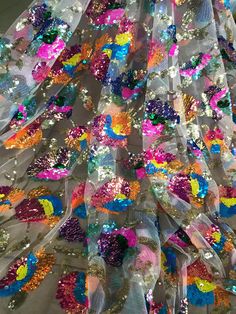 "5 YARDS / Colorful Floral Sequin Embroidery Tulle Mesh Lace / Fabric by the Yard We sell this fabric in 5 YARD INCREMENT Multi color embroidery on clear mesh ground fabric 100% Polyester Width - 47/48\" Stretch: Moderate Stretch Use - Apparel, Costumes, Appliqué, Wedding/Evening gowns, Formal Wear, Dresses, Crafts ACTUAL PRODUCT COLORS MAY DIFFER FROM IMAGE ON YOUR COMPUTER DUE TO DIFFERENT MONITOR SETTINGS ORDER PROCESS: * Sold by the yard. * No exchanges or returns. PACKING YOUR ORDER: *CUT O Party Multicolor Embroidered Fabric With Sequins, Multicolor Embroidered Sequin Fabric For Party, Elegant Multicolor Embellished Sequin Fabric, Multicolor Festive Sequin Fabric, Embroidered Multicolor Lace Sequin Fabric, Sequins Embroidery, Tassel Fringe, Jacquard Fabric, Drapery Fabric