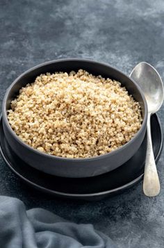 a bowl filled with oatmeal next to a spoon