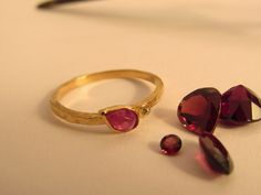 If you want to pay with PayPal, please contact me. Ring details: * The ring made from 14 karats solid yellow gold. * Ring width 0.05inch/ 1.5mm. * The house stone diameter 0.17x0.27inch/ 4.5x7mm. * Natural teardrop red Ruby. * 1 white diamond 0.01ct HVS1. Beautiful gold ring bezel set with a ruby and diamond. Rough but accurate. Handmade one of a kind. A perfect present for any occasion. Available in all sizes, color, gold and karat, and matte or shining finish. IF YOU WANT A CUSTOM ring please Gold Ruby Birthstone Ring With Rose Cut Diamonds, Dainty Yellow Gold Ruby Ring With Rose Cut Diamonds, Beautiful Gold Rings, Star Ruby Ring, Ring Bezel, Gold Ring Sets, Custom Ring, Star Ruby, Red Band