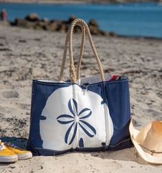 Eye-catching and sturdy, this bag is built for the beach, but you’re sure to reach for it any time you need a getaway bag that holds it all and keeps you organized with interior pockets. Washable and water resistant, the tote has an outer pocket to holds wet, sandy items. For nature lovers, it’s an eco-friendly choice that's sure to bring back memories of great beach walks. The lucky sand dollar has deep symbolism for the spiritual among us and is also a reminder of the many gifts of the sea. Coastal Style Tote Bag For Daily Use, Summer Outdoor Bag With Removable Pouch, Coastal Style Travel Tote Bag, Canvas Beach Bag With Removable Pouch For Vacation, Summer Beach Bags For Outdoor, Everyday Canvas Beach Bag For Beach Season, Beachy Canvas Beach Bag For Everyday Use, Canvas Beach Bag With Double Handles, Everyday Canvas Beach Bag For Vacation