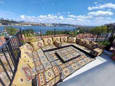 a couch sitting on top of a patio next to a railing