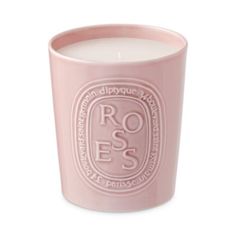 a pink candle with the words roses on it