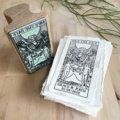 two tarot cards sitting on top of a wooden table