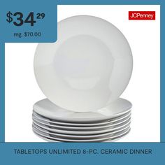 a stack of white plates sitting on top of each other