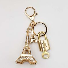 a gold keychain with the eiffel tower on it and a lock