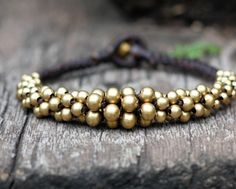 Ball Brass Bracelet by brasslady on Etsy, $8.00 Brass Beaded Bracelets For Festivals, Bohemian Gold Braided Bracelet With Beads, Adjustable Brass Beaded Bracelets With Gold Beads, Gold Hand-strung Braided Bracelet For Festivals, Gold Beaded Braided Bracelets For Festivals, Adjustable Bronze Beaded Brass Bracelets, Gold Fair Trade Beaded Jewelry, Bohemian Gold Braided Bracelets With Waxed Cord, Gold Waxed Cord Beaded Bracelets With Sliding Knot