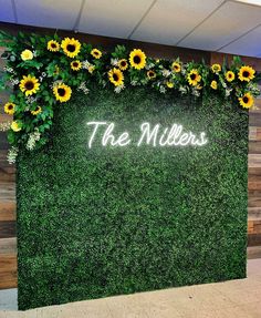 the miller's sign with sunflowers and greenery in front of it