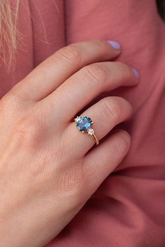 With a brilliant cut like that, this ring is nothing but pure brilliance in itself. With the prettiest blue color of the London Blue Topaz, the Khloe ring with two side moissanites, sparkles like there is no tomorrow. Celebrate your milestones or special occasions with this ring as the perfect gift for a new mom, or as a best friend's gift, or just as an everyday celebration of life in general. Details: Center stone Gemstone: London Blue Topaz Stone Shape: Oval Measurements: approx. 9x7mm Side s There Is No Tomorrow, London Blue Topaz Engagement Rings, Topaz Wedding Ring, No Tomorrow, Blue Engagement Ring, Blue Topaz Jewelry, Cute Engagement Rings, Sparkly Ring, Colored Engagement Rings