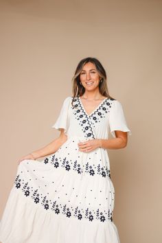 Introducing the Shira Dress. Elevate your wardrobe with this embroidered cotton tiered maxi dress. With a v neckline and nursing friendly snap button, this fully lined dress has a loose and relaxed fit, and a gorgeous flow silhouette. Easy to pull over for effortless style. Model is 5'6 wearing a small 100 Cotton Measurements S: Bust 32” | Waist 28” + stretch | Hips 44” | Length 52” M: Bust 35” | Waist 29” + stretch | Hips 45” | Length 52.5” L: Bust 38” | Waist 30” + stretch | Hips 46” | Length White V-neck Tiered Dress For Summer, White V-neck Tiered Casual Dress, White Casual Maxi Tiered Dress, White Casual Maxi Length Tiered Dress, Floral Embroidered V-neck Maxi Dress For Brunch, Floral Embroidered V-neck Midi Dress For Vacation, White Tiered Maxi Dress For The Beach, Flowy Floral Embroidered Maxi Dress, White Bohemian Tiered Midi Dress