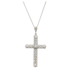 Vintage 1925-1930 18k white gold cross with excellent detailing, 17 rose cut diamonds and one brilliant cut center diamond. 18k white gold 18 inch chain. 1 round diamond, I SI approx. .4cts 17 rose cut diamonds, H-I VS- SI approx. .21cts 18k white gold Stamped: 18k 6.6 grams Top to bottom: 55.6mm or 2.20 Inches Width: 28.6mm or 1.13 Inches Inches Depth or thickness: 6.0mm Chain: 18 Inches Cross-shaped Diamond Necklace With Single Cut Diamonds, Diamond White Cross Necklace With Single Cut Diamonds, Diamond Cross Necklace With Single Cut Diamonds, Luxury White Gold Cross Necklace, Luxury Formal Cross Pendant Necklace, Luxury Crucifix Cross Necklace For Formal Occasions, Luxury Diamond White Diamond Cross Necklace, Classic Diamond Cross Necklace For Formal Occasions, Classic Platinum Necklace With Rose Cut Diamonds