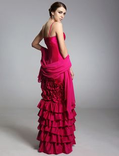 a woman in a pink dress standing with her back to the camera