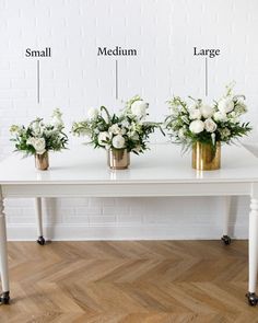 three vases with white flowers are sitting on a table, labeled in the words small medium large