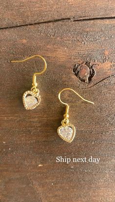 Beautiful gold-toned heart charm earrings with sterling gold french hooks.  Perfect staple earrings to add to any outfit or makes a lovely gift to a friend ✨  Ships for free! I take only 1-2 business days to get my items shipped out to you (usually the day you place your order).  See items like this and more from my shop. https://www.etsy.com/shop/InVogueTrinkets?ref=related&listing_id=1148603641#items Staple Earrings, Earrings Heart, Buy Earrings, Heart Crystal, Trendy Earrings, Mini Heart, Gold Heart, Gorgeous Earrings, Heart Of Gold