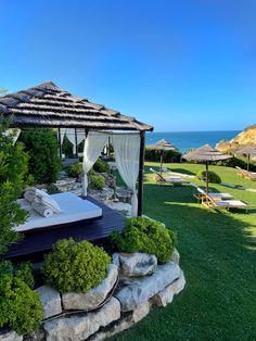 an outdoor spa area next to the ocean