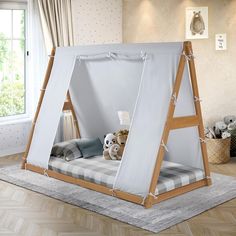 a child's bed with a tent attached to it