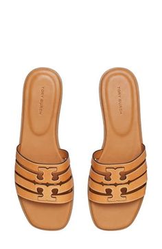 A dimensional Double-T logo stands out atop the strappy vamp of this breezy leather slide sandal. Leather upper and lining/rubber sole Imported Calf Leather Slip-on Sandals With Cushioned Footbed, Luxury Slip-on Slides For Spring, Classic Tan Sandals With Leather Lining, Tan Leather Footbed Slip-on Sandals, Classic Tan Sandals With Leather Sole, Luxury Slide Mules For Spring, Luxury Spring Slide Mules, Designer Leather Slip-on Slides, Classic Tan Slip-on Sandals