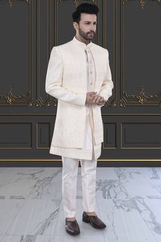 Indulge in luxury and sophistication with our Mens Sherwani- U2-S382. This open jacket sherwani is perfect for special occasions, showcasing your refined and elegant taste. Elevate your style and make a statement with this premium piece. Elegant Semi-formal Sets For Eid, Elegant Bandhgala With Dabka Work For Festive Occasions, Elegant Cream Bandhgala With Chikankari Embroidery, Elegant Festive Bandhgala With Dabka Work, Elegant Unstitched Long Sleeve Nehru Jacket, Elegant Front Open Sets With Dabka Work, Luxury Sets With Resham Embroidery For Eid, Luxury Eid Sets With Resham Embroidery, Luxury Fitted Sherwani For Semi-formal Occasions