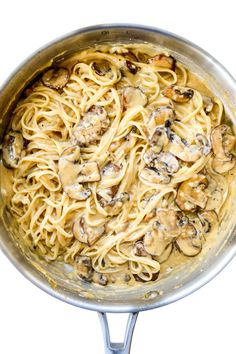 a pan filled with pasta covered in mushrooms