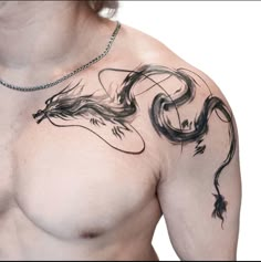 a man's chest with a dragon tattoo on his left side and an arrow in the middle