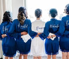 a group of women in blue robes standing next to each other