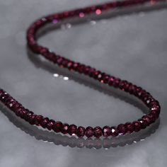 Garnet protects the wearer from negativity and evil thoughts. It induces passion, fire, energy, stability, and is believed to bring good luck in love and relationships. Garnet is a stone meant to bring success in life and helps to achieve the goals set in life by its possessor. Product Details : Handmade Necklace Gemstone : Garnet Gemstone Color : Purple Gemstone Treatment : Natural Gemstone Origin: Mozambique Gemstone Size : 3mm Gemstone Shape : Rondelle Gemstone Finish : Faceted Necklace Lengt Purple Garnet, Garnet Bracelet, Necklace For Girlfriend, Handmade Beaded Necklaces, Garnet Necklace, Gemstone Beaded Bracelets, Ruby Jewelry, Rhodolite Garnet, Genuine Turquoise