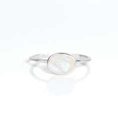 You'll fall in love with an iridescence of this Rainbow Moonstone ring. This is a perfectly sized oval to compliment any collection. Popular as a birthday gift for those June babes and Rainbow Moonstone lovers alike. This stone is beautifully faceted and bezel set in a 925 sterling silver band or plated with 18k vermeil gold. Gemstone is approximately 8 x 6mm.Band has 925 stamp on inside.Please note that each ring is handmade and there may be some slight variations from listing photo.Available i Moonstone Stackable Rings For Gift, Oval Moonstone Stackable Rings As Gift, Oval Moonstone Gemstone Ring, Minimalist Oval Moonstone Birthstone Ring, Oval Gemstone Stackable Rings For Gift, Oval Birthstone Ring Gift, Iridescent Birthstone Rings For Gift, Minimalist Oval Opal Ring For Gift, Minimalist Oval Opal Ring Gift