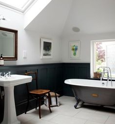 a bathroom with a claw foot bathtub and pedestal sink in the center, along with two stools on either side of the tub