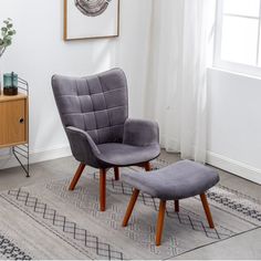 a chair and footstool in a living room with a rug on the floor