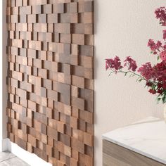 a vase filled with flowers sitting next to a wooden paneled wall on top of a counter