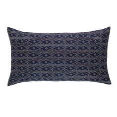 a blue and white pillow with an intricate design on the front, along with a black background