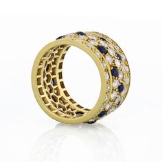 A stunning Cartier ring featuring the famous Nigeria Panthere design in 18k yellow gold. Made in 1980's, this 5-row band is pave-set with natural white diamonds and accented with cabochon blue sapphires for elegant contrast.Center Diamond Weight: 5.60Measurements: Size 6.75Metal Type: 18K Yellow GoldMetal Weight: 10.1 gr.Ring Size: 6.75Signed: CartierCondition: Good.Stock: RR5975 Cartier Rings In Yellow Gold With Pave Setting, Luxury Yellow Gold Sapphire Ring With Pave Setting, Luxury Sapphire Ring In Yellow Gold With Pave Setting, Cartier Yellow Gold Rings With Single Cut Diamonds, Cartier Yellow Gold Rings With Prong Setting, Cartier Yellow Gold Jewelry With Prong Setting, Gold Sapphire Ring With Pave Setting, Emerald Cut Diamond Ring, Sapphire And Diamond Ring