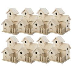 six wooden bird houses with pickets on them