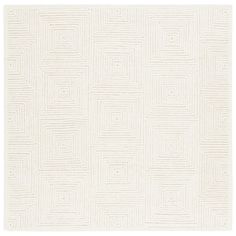 a white rug with squares and lines in the middle, on top of a white floor