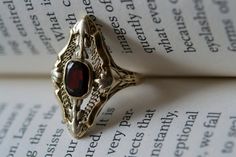 Whimsical 1920s Navette shaped yellow gold filigree ring with oval red garnet.  Circa 1920-1930. Vintage Unique Wedding Rings, Red And Gold Jewelry Aesthetic, Elegant Garnet Ruby Ring Stamped 14k, Victorian Yellow Gold Ruby Ring With Intricate Design, Victorian Ruby Ring In Yellow Gold With Intricate Design, Antique Garnet Rings For Formal Occasions, Vintage Ceremonial Gemstone Ring, Vintage Ceremonial Ring With Gemstone, Vintage Ceremonial Rings With Gemstones