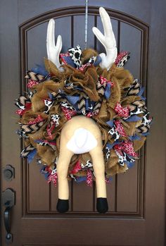 a deer head wreath hanging on the front door