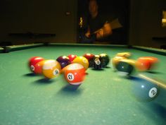 a pool table with several billiards on it